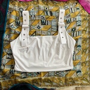 Tiger mist white cropped tank top with silver buckles on strap, size medium.